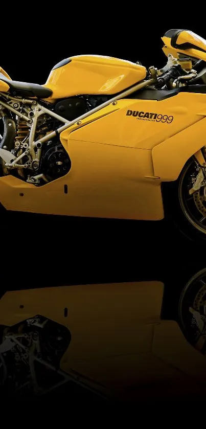 Yellow Ducati motorcycle on black background with sleek reflection.