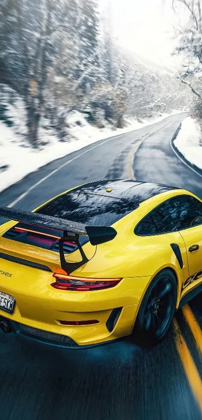 Yellow sports car driving on snowy mountain road.