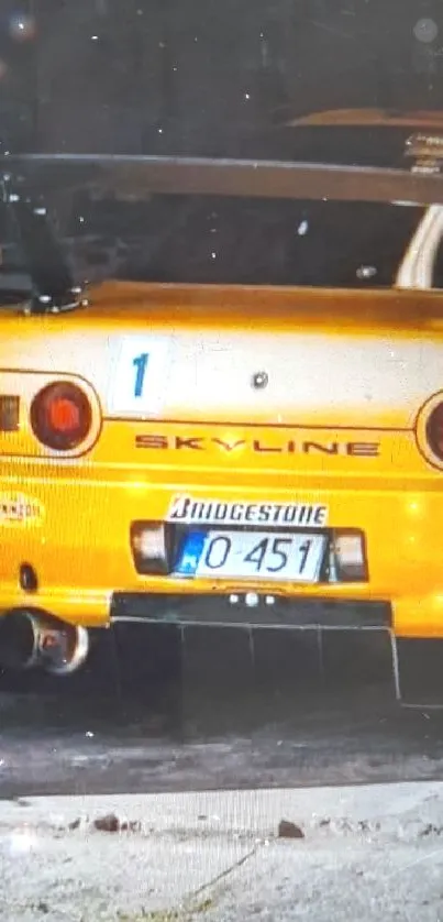 Rear view of a yellow sports car in garage.