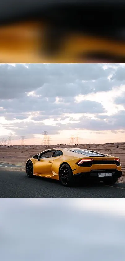 Yellow sports car on open road with cloudy sky.