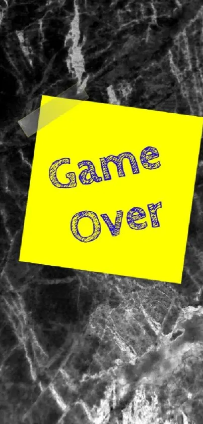 Yellow sticky note with 'Game Over' on dark textured background.