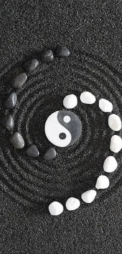 Yin Yang stones in spiral on black sand.