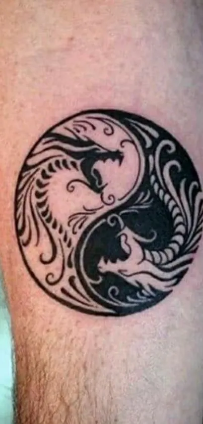 Yin yang tattoo design in black and white on skin.