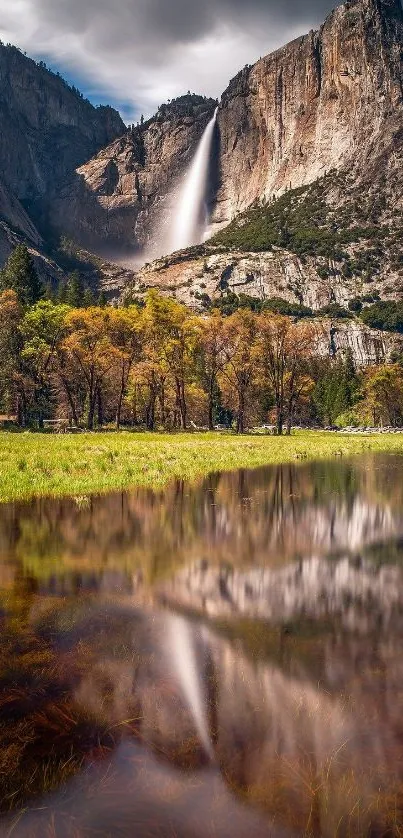 Yosemite waterfall reflecting on a tranquil lake with vibrant fall colors in the foreground.