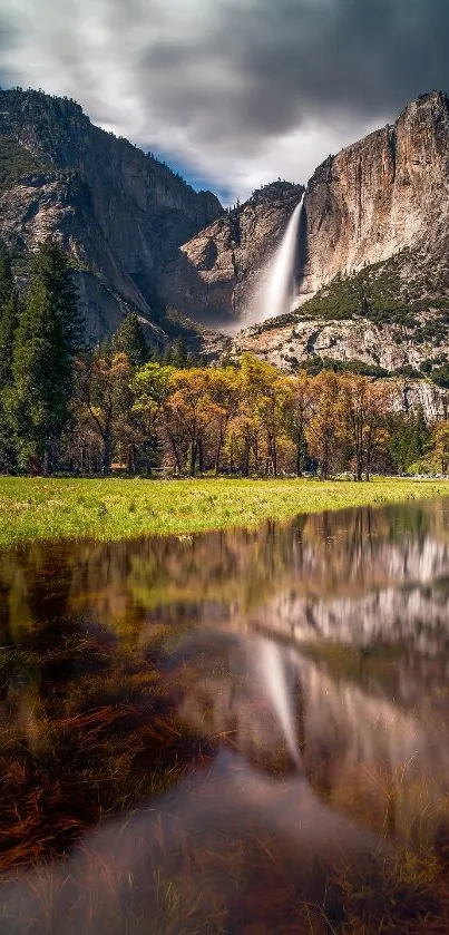 Yosemite waterfall with scenic view of mountains and lush greenery under a cloudy sky.