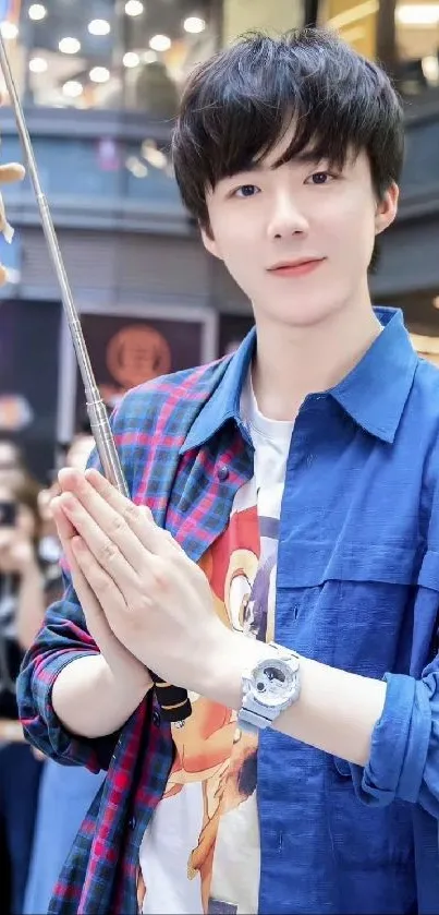 Young man in blue shirt with plush toy, urban style.