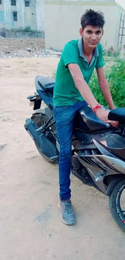 Young man with black motorcycle in urban setting