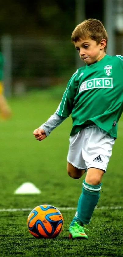Young soccer player kicking a ball on a vibrant green field.