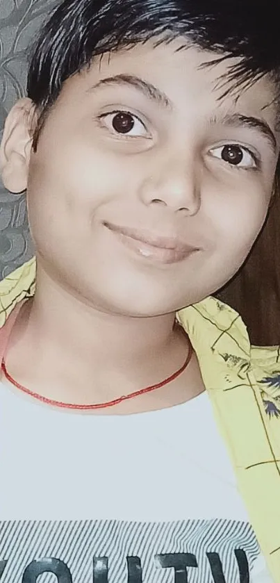 Portrait of a smiling young person wearing a yellow shirt.