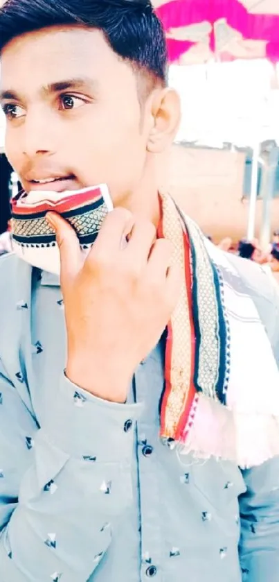 Young man with colorful scarf in outdoor setting.