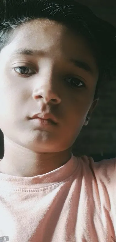 Youthful portrait with soft lighting on a peach background.