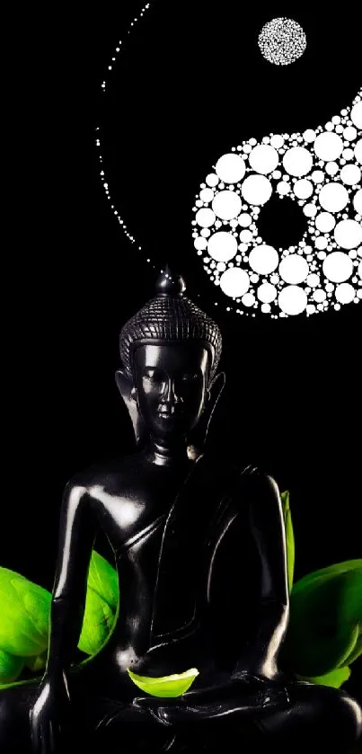 Buddha statue with yin yang and green leaves on black.