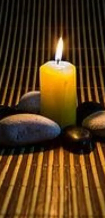 Yellow candle and stones on bamboo mat wallpaper.