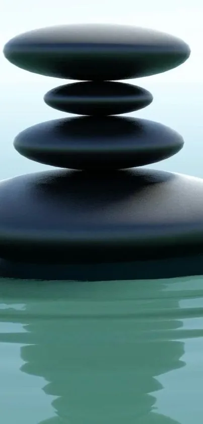 Stack of zen stones with reflection on calm water wallpaper.