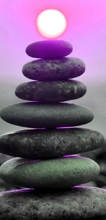 Stack of zen stones with a pinkish-purple glow.