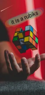 Floating Rubik's Cube above hand with red backdrop.