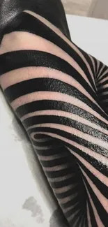 Abstract black stripe tattoo on arm with unique pattern design.