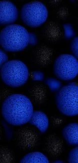 Abstract wallpaper with blue and black textured spheres.