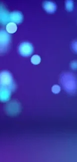 Abstract blue bokeh mobile wallpaper with blurred light dots.