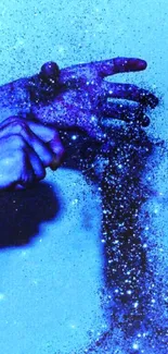 Hands and glitter art on a blue background.