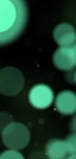 Abstract green bokeh wallpaper with soft glowing circles on a dark background.