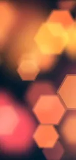 Abstract wallpaper with hexagonal shapes in a warm orange glow.