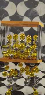 Abstract art with yellow marbles in glass on geometric background.