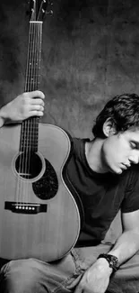 Black and white wallpaper with man and acoustic guitar in reflective pose.