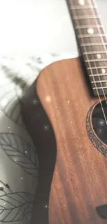 Acoustic guitar on a cozy chair with a leaf-patterned cushion.