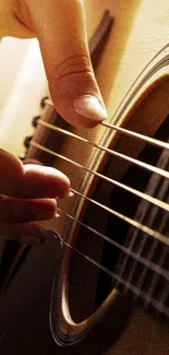 Close-up of a hand plucking acoustic guitar strings.