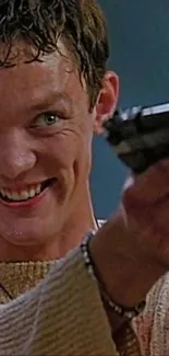 Smiling man aiming gun in action scene.