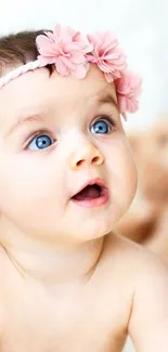 Adorable baby girl with pink headband and teddy bears in soft pink tones.