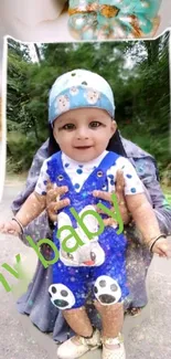 Adorable baby in blue outfit with playful accents.