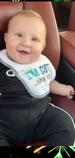 Smiling baby seated in car with colorful festive frame.