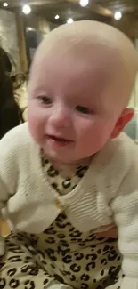 Adorable baby in cozy white sweater with a leopard print outfit.