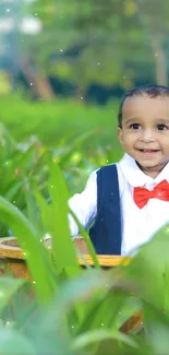 Smiling baby surrounded by green plants in a vibrant setting.