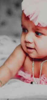 Adorable baby in pink outfit with a cute smile.