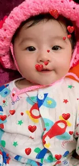 Cute baby with pink hat and colorful outfit in a joyful setting.