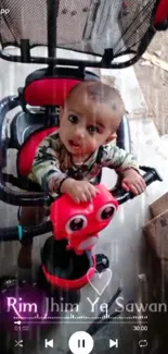 Adorable baby on a tricycle with a gray background