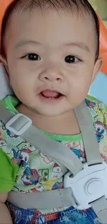 Adorable baby smiling with colorful shirt in stroller.