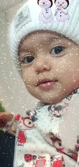 Adorable baby with a snowy sparkle effect in a winter themed wallpaper.