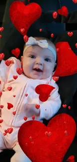 Smiling baby surrounded by red hearts on a mobile wallpaper.