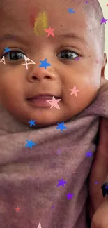 Cute baby with colorful stars overlay on mobile wallpaper.