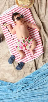 Cute baby in sunglasses on a beach towel, ready for summer.