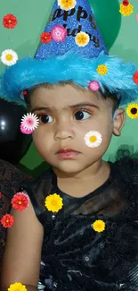 Child wearing a blue birthday hat with green background.