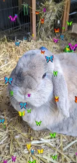 Grayish tan bunny with colorful butterflies resting on straw.