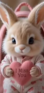 Adorable bunny holding heart with pink background.