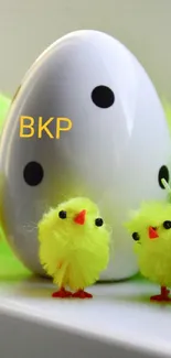 Cute yellow chicks with Easter egg on display.