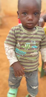 Adorable child in casual attire in a warm setting.