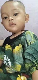 Cute child in a floral patterned shirt indoors.